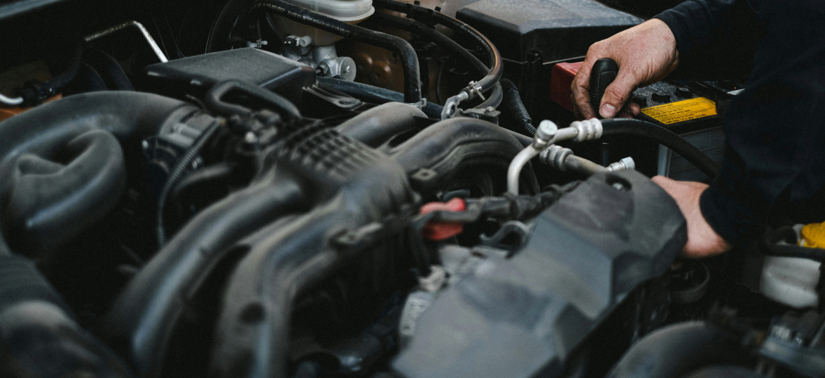 hands fixing engine during diagnostics