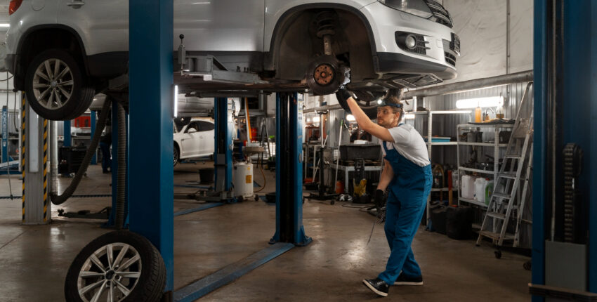 Vehicle undergoing maintenance at auto repair shop