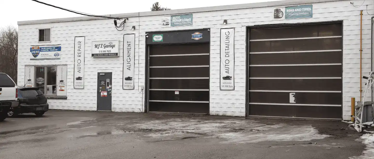 MJZ Garage auto repair shop with two large garage doors and signage.